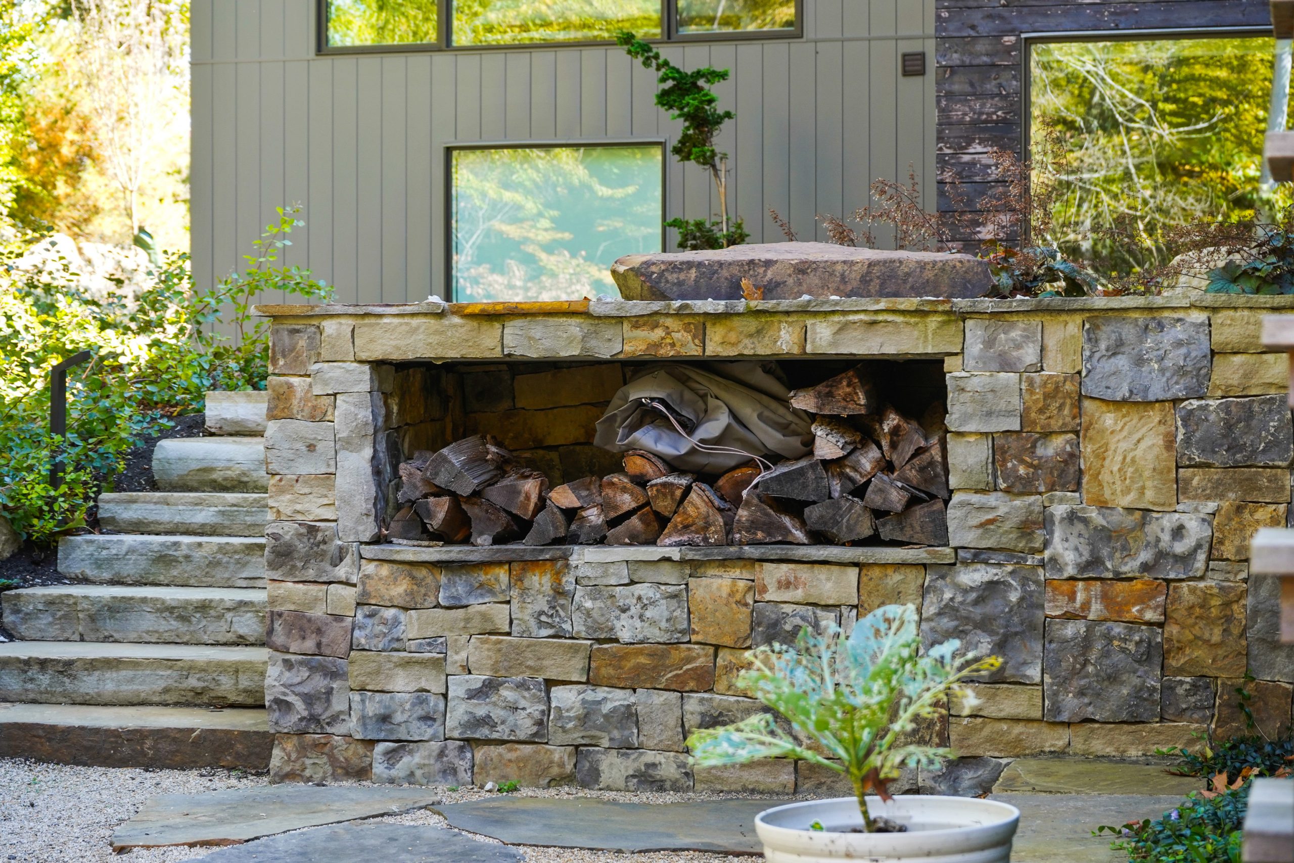 Firewood hardscape surrounded by plants