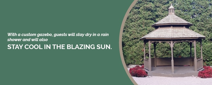 A plain wooden gazebo with low red bushed to each side and set in front of a tall bushy background cropped into a circle with text to the left reading "With a custom gazebo, guests will stay dry in a rain shower and will also stay cool in the blazing sun."