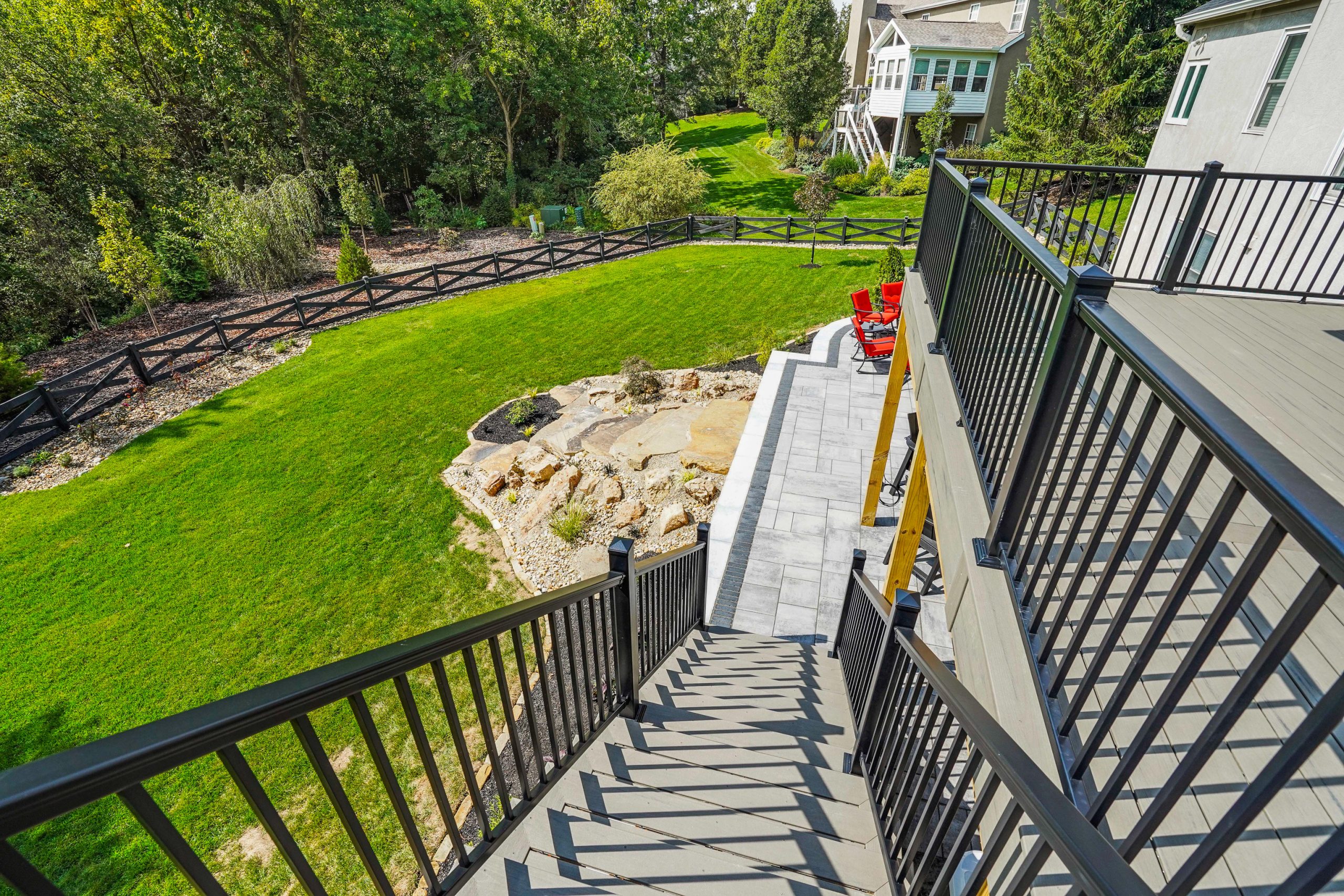 Upstairs view of property with lawn within fence and trees outside fenced area