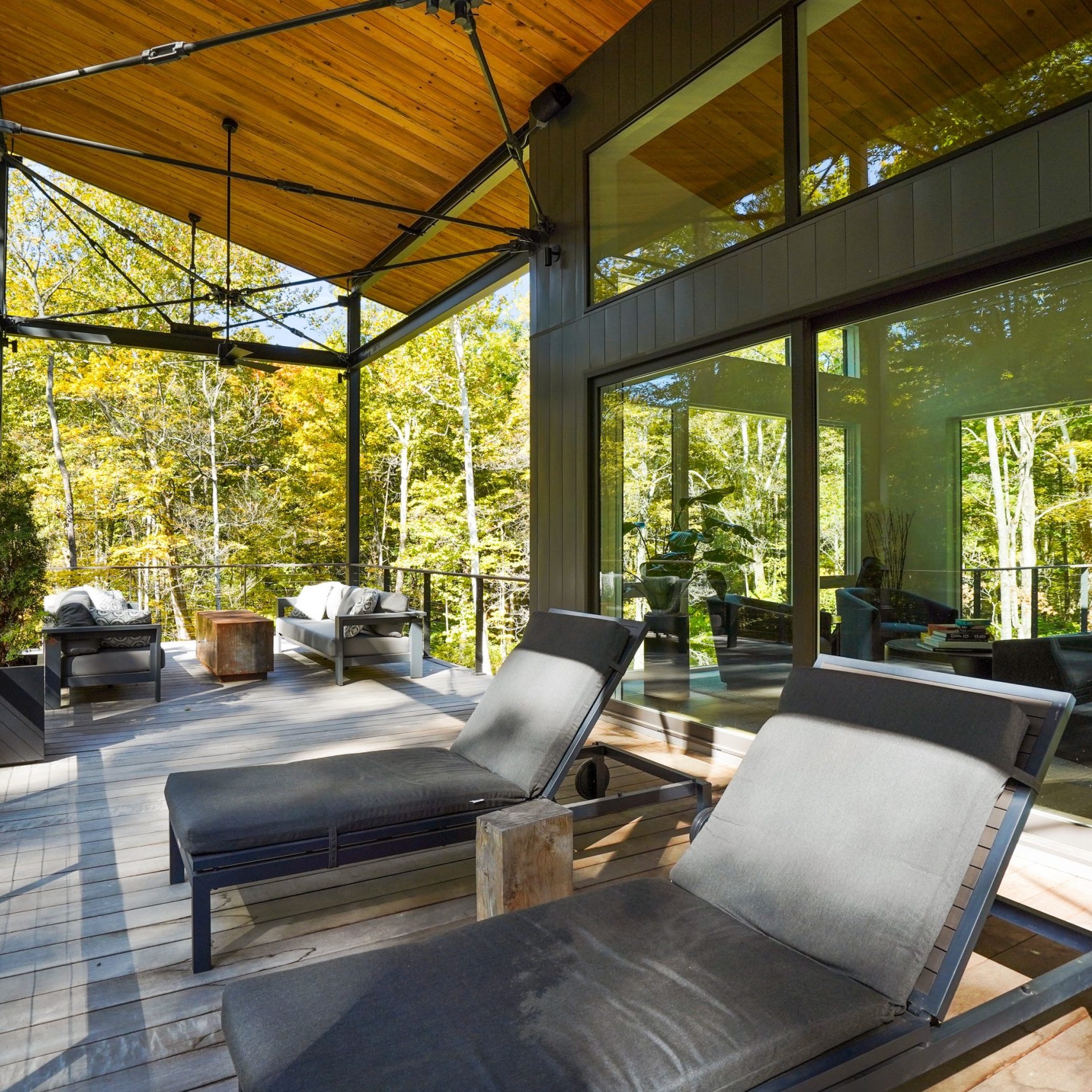 Lounge area with comfy chairs overlooking trees on the side